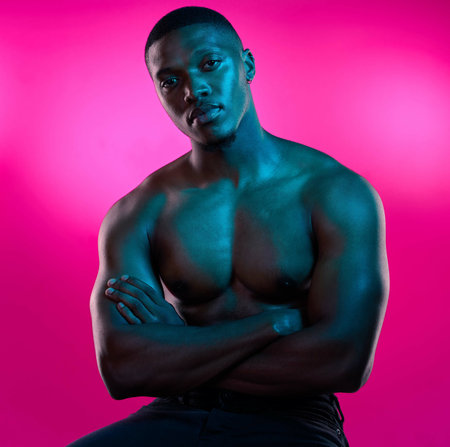 When life gets tough, remember youre tougher. Studio shot of a fit young man posing against a pink background.の写真素材