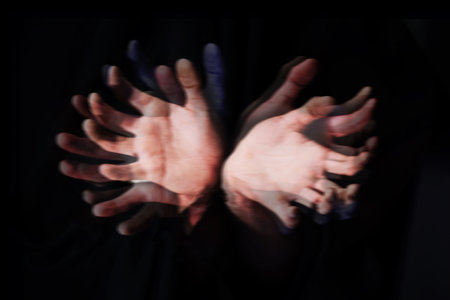 Blur, ghost hands on black background and closeup in studio isolated on an abstract dark backdrop. Palm, fingers and demon, fantasy and surreal horror, fear danger and scary nightmare on Halloweenの写真素材
