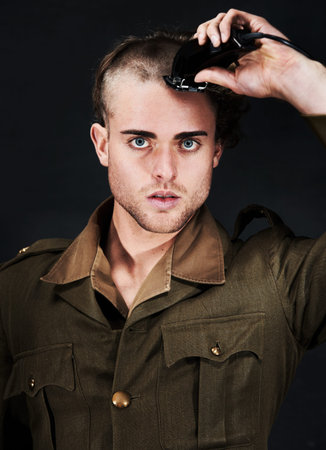 Military, soldier and portrait of man in haircut at studio isolated on a black background. Army,...