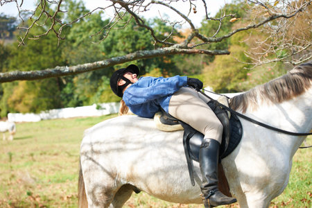 Tree, branch or woman horse riding in countryside outdoor with rider or jockey for recreation or wellness. Sports, flexible girl or equestrian ducking in training, exercise or workout in farm ranchの写真素材
