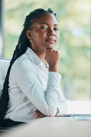 Im here to fulfil my career goals. Cropped portrait of an attractive young businesswoman sitting at her desk in the office.の写真素材
