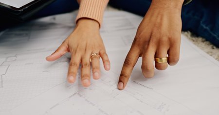 Closeup, hands and couple with blueprint, cooperation or construction with planning, project or real...