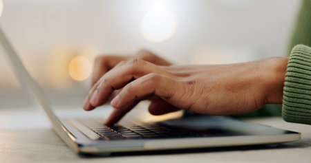 Closeup, hands and typing on a laptop keyboard for communication, online business or website. Zoom, table and a worker with a computer for internet, search or working on a pc for remote work or chatの写真素材