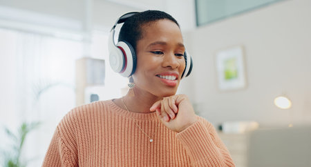 Woman, headphones and smile by laptop for remote work from home with thinking process, ideas or...