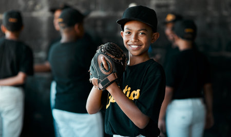 I just love baseball. Portrait of a young baseball player wearing baseball mitts with his teammates standing in the background.の写真素材
