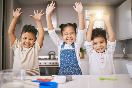 Its bake day. three cheerful siblings celebrating while baking in a kitchen.