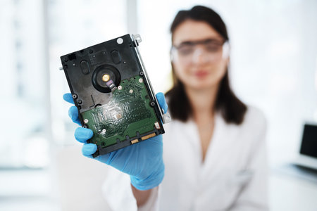 Repaired and ready for use. a young woman repairing computer hardware in a laboratory.