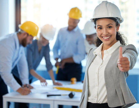 Are we doing a good job. a young businesswoman showing a thumbs up at work.