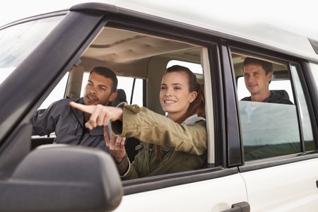 Theres where we need to be. a young woman shpowign her friend where to go while on a roadtrip.