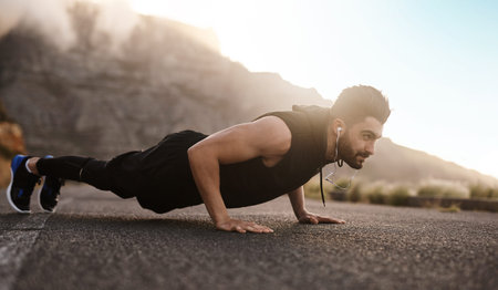 You earn so much more when you dont give up. a sporty young man doing pushups while exercising...