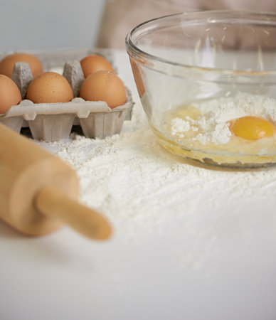 This is shaping up to be a tasty dish. Closeup shot of a woman making dough in her kitchen.の写真素材