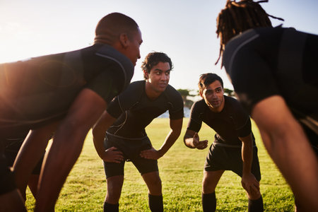 Coming up with a game plan. a diverse group of sportsmen huddled together before playing a game of rugby.の写真素材