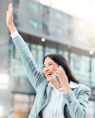 And then one day, success came her way. a young businesswoman using a smartphone and gesturing to order a cab against an urban background.の写真素材
