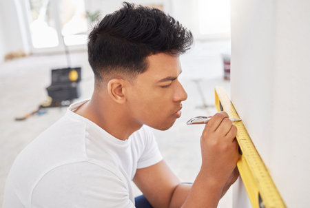 When I do a job, I do it right. a man using a spirit level while renovating a house.