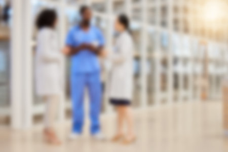 Blurred hospital, doctors and team of nurses consulting for medical services, advice and expert management. Defocused group of healthcare employees meeting for wellness, support or planning in clinicの写真素材
