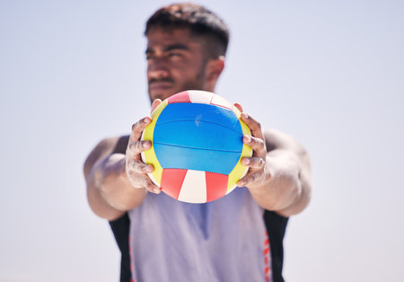 Beach, fitness or man with volleyball to serve for game, workout training or sports training in summer. Thinking, athlete or hands of player holding ball ready to start contest or exercise at oceanの写真素材
