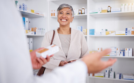 Pharmacy, consulting and smile with woman in store for shopping, medicine and help. Retail, medical and healthcare with senior customer and pharmacist for expert, information and prescriptionの写真素材