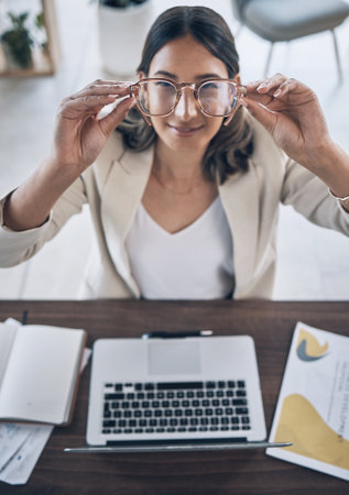 Hands, woman or glasses for vision wellness, healthcare or clear view of law firm goals, target or innovation. Top view, smile or happy worker and eyewear, laptop technology or lawyer paper documentsの写真素材