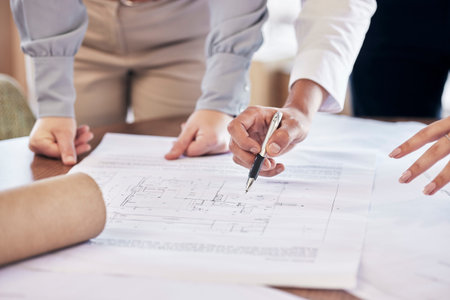 Team work, hands or architect drawing a blueprint or planning a real estate building or development...