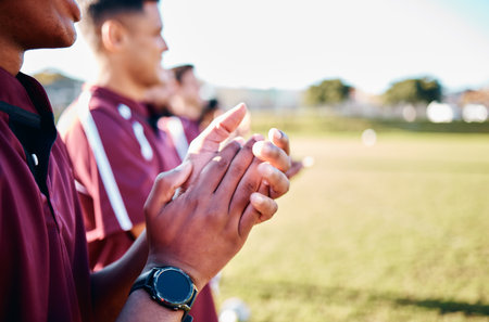 Sports, closeup and hands with team, applause and celebration for winning, victory and happiness. Zoom, group and players on field, joyful and cheerful for teamwork, success and achievement outdoorの写真素材