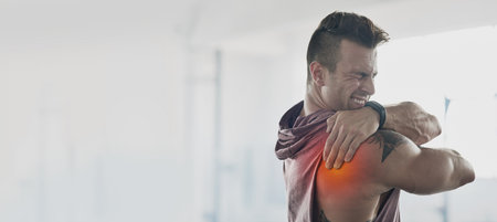 Man, training and shoulder pain with mockup space at gym for workout, exercise and muscle injury. Bodybuilder, anatomy emergency or problem by mock up, wall background or medical accident with handsの写真素材