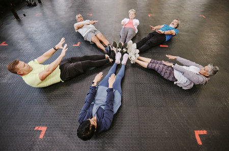 Gym, fitness workout and group doing exercise for abdomen together in a health training class....