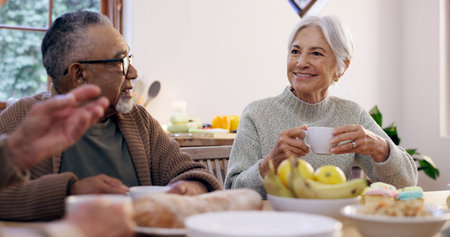 Friends, tea party and a group of senior people in the living room of a community home for a social....