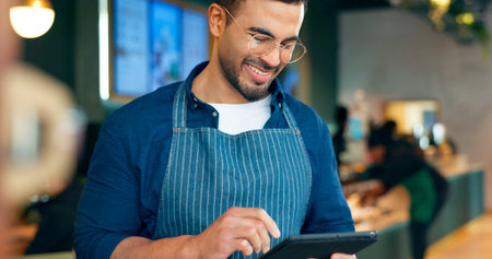 Cafe, happy man and barista on tablet of restaurant sales, online management or customer service...