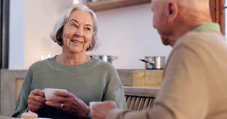 Love, retirement and an elderly couple drinking tea in the dining room of their home together in the...