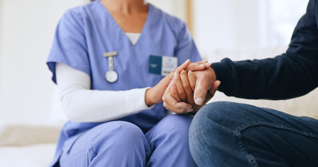 Nurse, patient and holding hands closeup for diagnosis news, consultation or test result support. Medical worker, person and fingers touch for anxiety stress or empathy wellness, report or exam hopeの写真素材