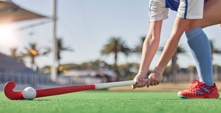 Hockey, sports and woman athlete on a turf field with a stick and ball for exercise, training and competition performance to win. Hands of hockey player on grass for sport goal, fitness and healthの写真素材