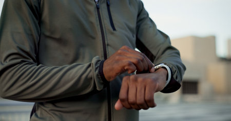 Hands, watch and runner outdoor for fitness, exercise or workout with monitor for performance or heart rate. Person, clock or check stopwatch, timer or cardiovascular progress for wellness and healthの写真素材
