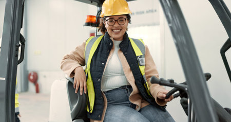 Engineer woman, forklift and smile in portrait for logistics, supply chain or working in warehouse. Employee, helmet and reflective gear for safety at shipping workshop in vehicle for transportationの写真素材