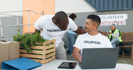 Team, volunteer and laptop for donation, charity and outreach program by people outdoor. Tech,...