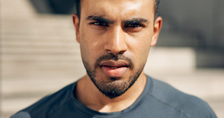 Portrait, fitness and a serious sports man outdoor in the city for commitment to health or wellness....
