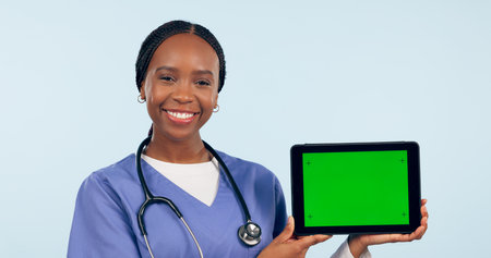 Green screen, doctor and portrait of black woman with tablet for telehealth, wellness and medical news. Healthcare, mockup and person on digital tech for clinic website in studio blue backgroundの写真素材