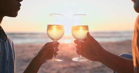 Sunset, beach and couple with wine, toast and anniversary with happiness, marriage and vacation....