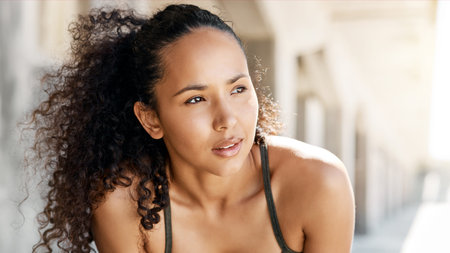 Time to train. an attractive young woman taking a moment to catch her breath during her outdoor...