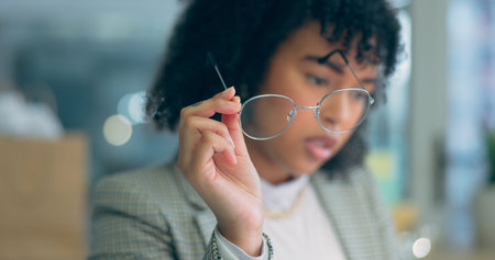 Hand, woman and holding glasses with reading, focus and business strategy in office or corporate...