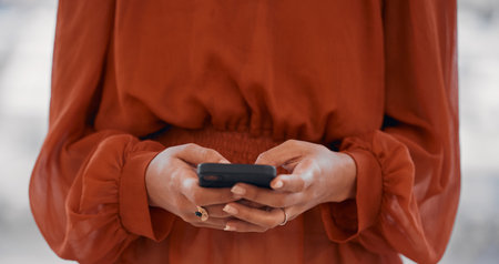 Woman, hands and typing in office with smartphone for social network, mobile website and digital...