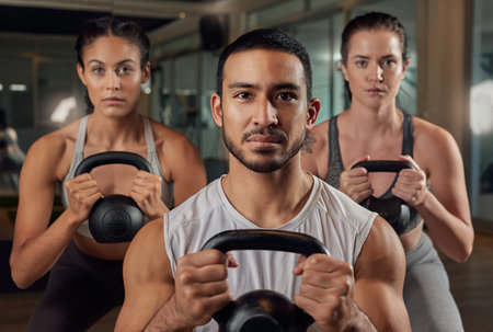 Adding some weight to their workout. Cropped portrait of three young athletes working out with...
