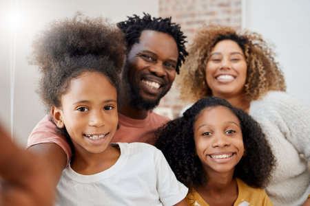 Smiling together, staying together. a young family taking a selfie at home.