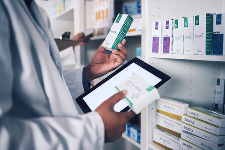 Pharmacist, tablet and hands for inventory inspection, box or medication on shelf at the pharmacy. Man, medical or healthcare professional checking stock, pills or medicine for storage at drugstoreの写真素材