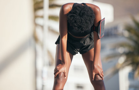 Woman, tired and stop for sports, running break or workout challenge outdoor. Female athlete, rest...