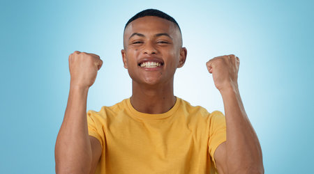 Man, portrait and excited for success with fist in studio to celebrate deal, promotion or yes to...