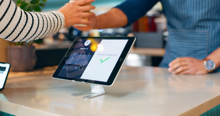 Coffee, tablet or hands of customer in cafe with cashier for shopping, sale or payment in checkout. Order, bills or closeup of barista giving service, beverage or tea drink to a person in restaurantの写真素材