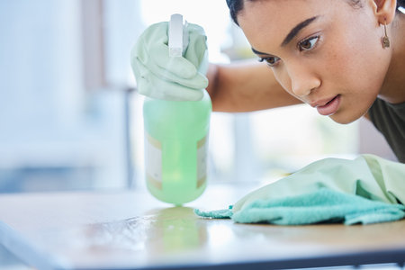 Clean, spray and woman cleaning a table at home for hygiene with a spray bottle product for fresh...