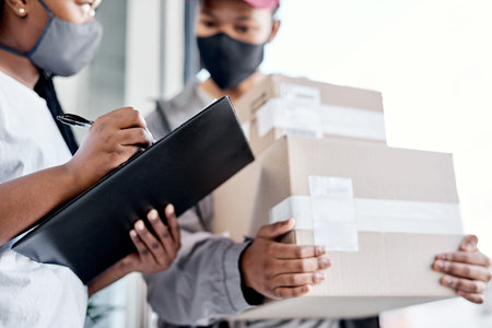 A five star rating for an excellent delivery service. a masked young woman signing for a delivery...