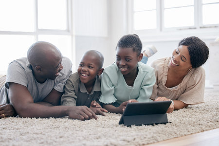 You dont choose your family. They are Gods gift. a family using s tablet while laying on the floor...