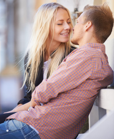 Couple, love or kiss in city with smile, relax or weekend date for romance outdoor in sun. English man, woman or bliss in connection in relationship, marriage or care in bond together in cambridgeの写真素材